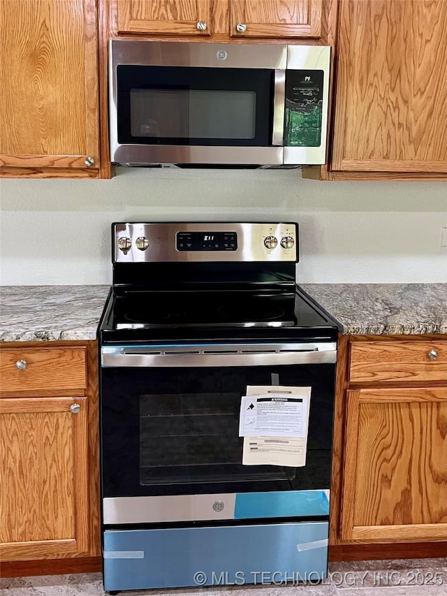 16547 County Road 1600, Ada, OK 74820 - kitchen with appliances with stainless steel finishes and brown cabinetry