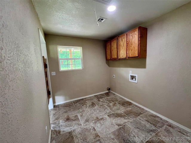 16547 County Road 1600, Ada, OK 74820 - laundry room with cabinet space, hookup for a washing machine, stone finish flooring, and electric dryer hookup