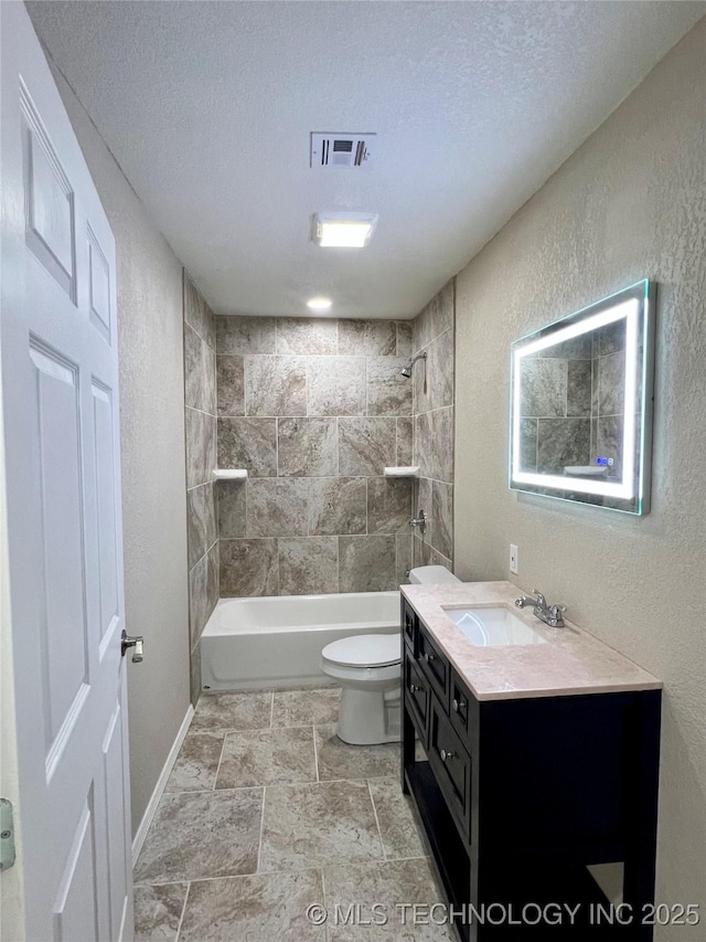 16547 County Road 1600, Ada, OK 74820 - full bath with vanity, a textured ceiling,  shower combination, a textured wall, and stone finish flooring