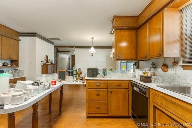 12725 S 168th E Ave, Broken Arrow, OK 74011 - kitchen with dishwasher, brown cabinets, light countertops, light wood-type flooring, and pendant lighting
