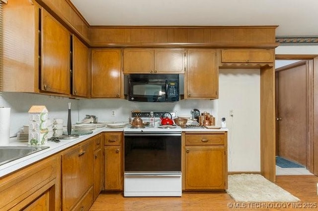 12725 S 168th E Ave, Broken Arrow, OK 74011 - kitchen with black microwave, white range with electric stovetop, light countertops, and light wood finished floors