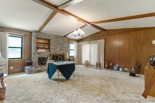 12725 S 168th E Ave, Broken Arrow, OK 74011 - living room featuring a chandelier, carpet flooring, wooden walls, a stone fireplace, and a textured ceiling