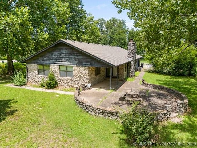 12725 S 168th E Ave, Broken Arrow, OK 74011 - back of property with a patio area, stone siding, a lawn, and a chimney