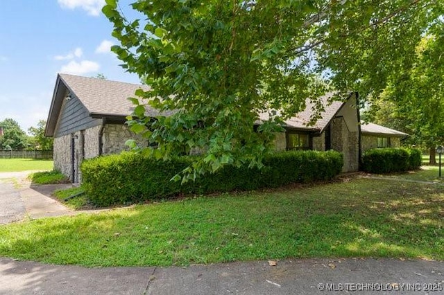 12725 S 168th E Ave, Broken Arrow, OK 74011 - view of side of home with stone siding and a yard