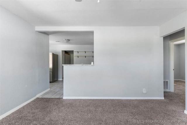 6711 E 10th St, Tulsa, OK 74112 - spare room featuring light carpet and baseboards