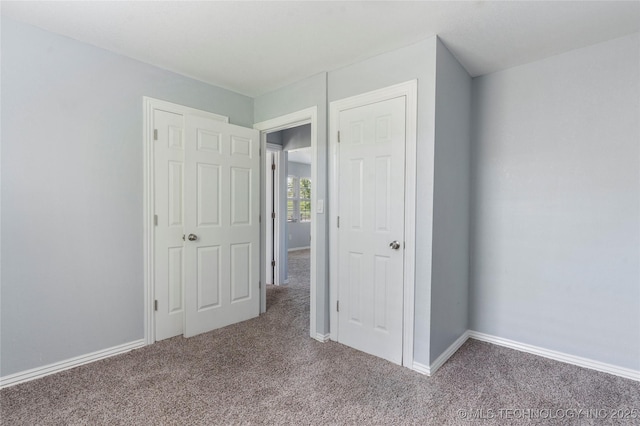 6711 E 10th St, Tulsa, OK 74112 - unfurnished bedroom featuring carpet and baseboards