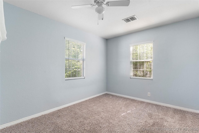 6711 E 10th St, Tulsa, OK 74112 - empty room with healthy amount of natural light, carpet, and ceiling fan