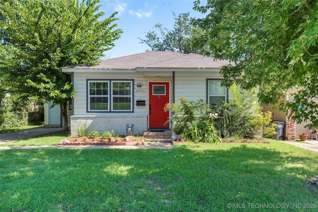 6711 E 10th St, Tulsa, OK 74112 - view of front of home featuring brick siding, a front yard, and a shingled roof
