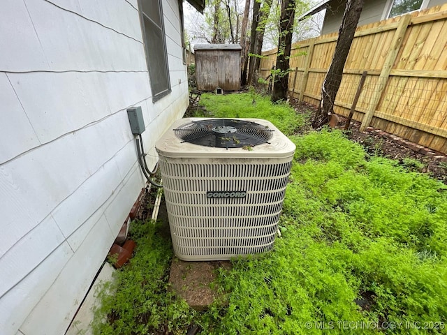 1225 S Quaker Ave, Tulsa, OK 74120 - exterior view of a central AC unit and a fenced backyard