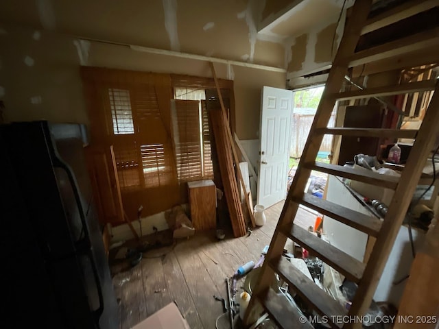 1225 S Quaker Ave, Tulsa, OK 74120 - unfurnished bedroom with wood-type flooring and freestanding refrigerator