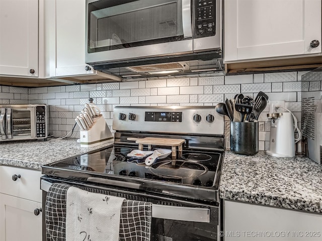 310 W Lee Ave, Sapulpa, OK 74066 - kitchen featuring appliances with stainless steel finishes, decorative backsplash, white cabinets, and light stone countertops