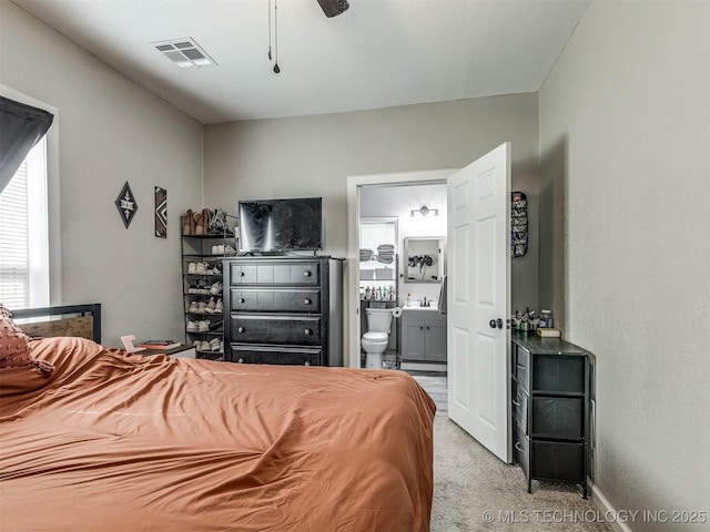 310 W Lee Ave, Sapulpa, OK 74066 - bedroom featuring light carpet, ensuite bath, and ceiling fan