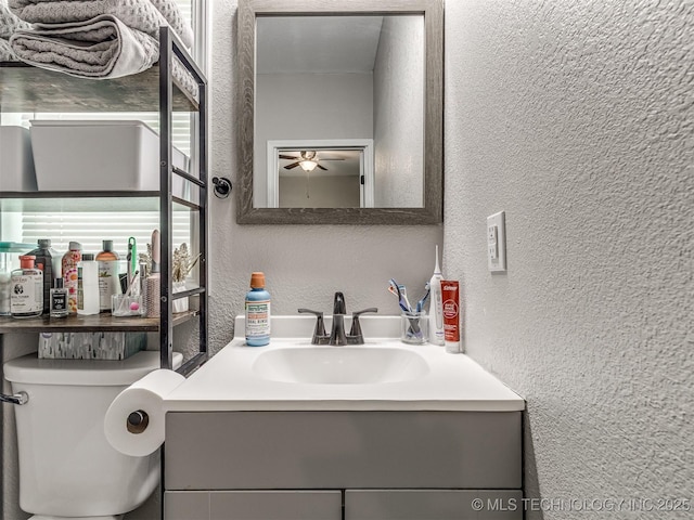 310 W Lee Ave, Sapulpa, OK 74066 - bathroom featuring a textured wall, vanity, and ceiling fan