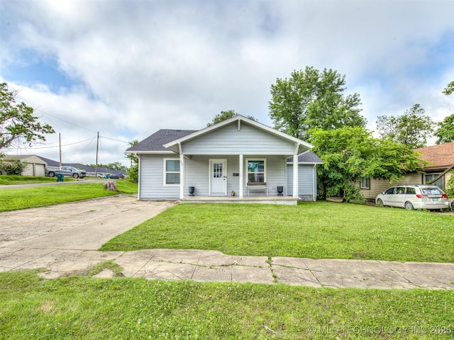310 W Lee Ave, Sapulpa, OK 74066 - bungalow-style house featuring a porch, a front lawn, and roof with shingles