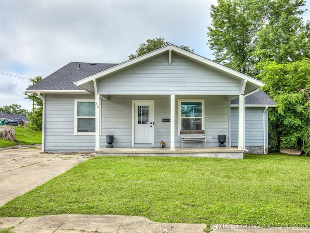 310 W Lee Ave, Sapulpa, OK 74066 - bungalow with covered porch, a front lawn, and roof with shingles