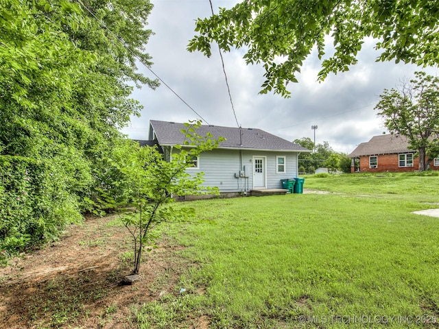 310 W Lee Ave, Sapulpa, OK 74066 - back of property with a yard and roof with shingles
