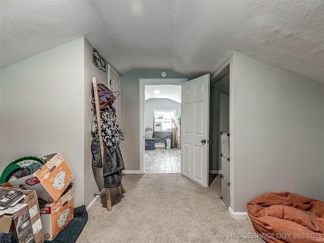 310 W Lee Ave, Sapulpa, OK 74066 - hall with vaulted ceiling, carpet flooring, and a textured ceiling