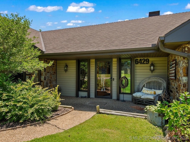 6429 Clear Creek Loop, Bartlesville, OK 74006 - entrance to property featuring a shingled roof and covered porch