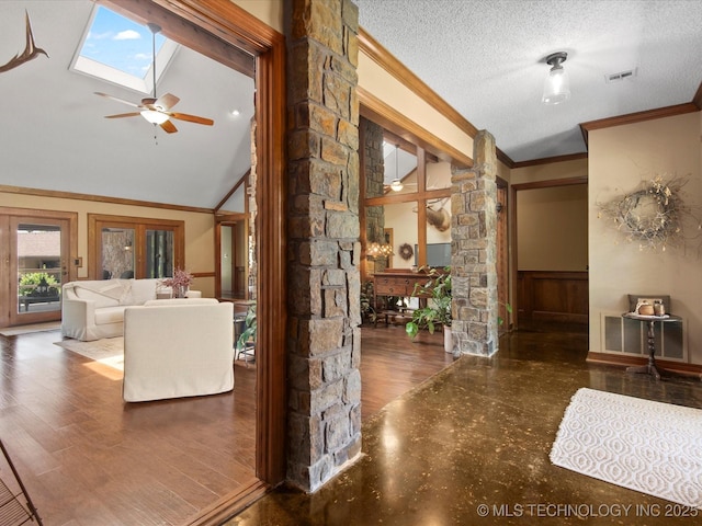 6429 Clear Creek Loop, Bartlesville, OK 74006 - living room with decorative columns, a skylight, crown molding, a ceiling fan, and a textured ceiling