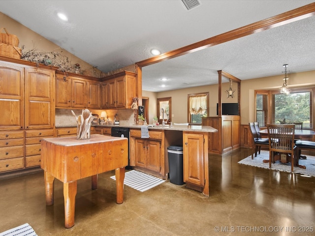 6429 Clear Creek Loop, Bartlesville, OK 74006 - kitchen featuring a peninsula, healthy amount of natural light, light countertops, brown cabinets, and recessed lighting