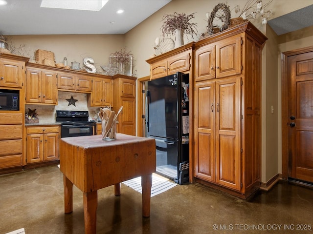 6429 Clear Creek Loop, Bartlesville, OK 74006 - kitchen with black appliances, a skylight, backsplash, concrete flooring, and recessed lighting