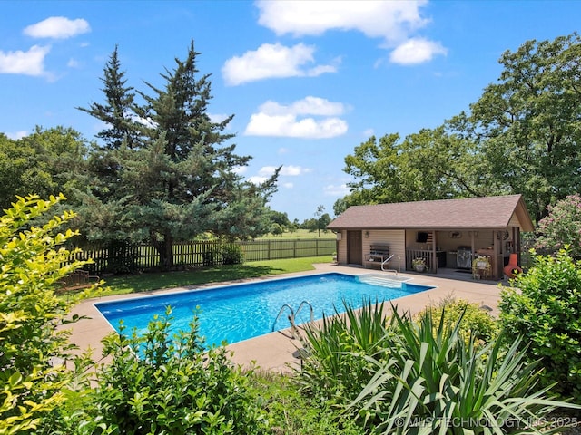 6429 Clear Creek Loop, Bartlesville, OK 74006 - view of swimming pool featuring a patio area and an outbuilding
