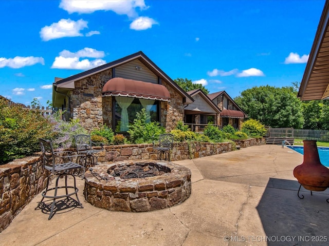 6429 Clear Creek Loop, Bartlesville, OK 74006 - view of patio / terrace featuring a fire pit