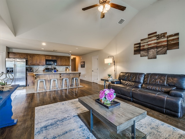 3409 E Quebec St, Broken Arrow, OK 74014 - living room featuring dark wood-type flooring, high vaulted ceiling, a ceiling fan, and recessed lighting