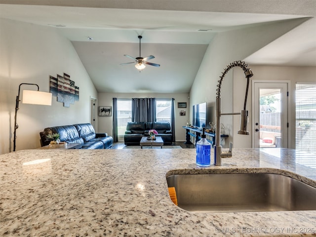 3409 E Quebec St, Broken Arrow, OK 74014 - kitchen featuring light stone counters, ceiling fan, open floor plan, and high vaulted ceiling