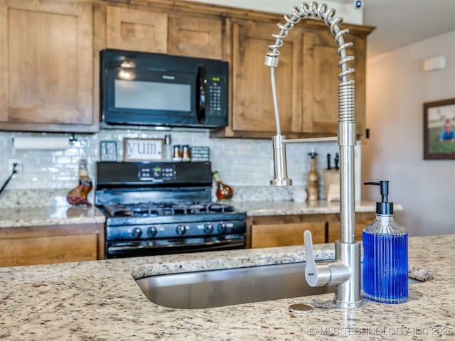 3409 E Quebec St, Broken Arrow, OK 74014 - kitchen with black appliances, decorative backsplash, brown cabinetry, and light stone countertops