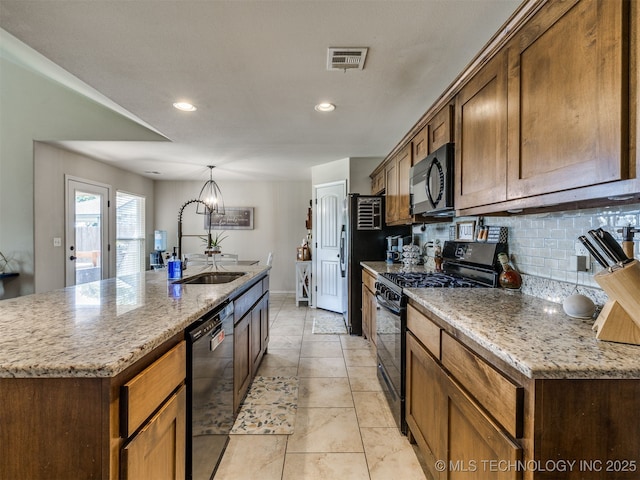 3409 E Quebec St, Broken Arrow, OK 74014 - kitchen with black appliances, decorative backsplash, an island with sink, light stone counters, and recessed lighting