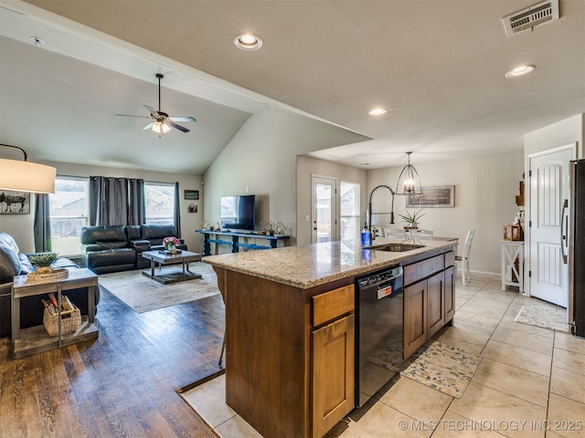 3409 E Quebec St, Broken Arrow, OK 74014 - kitchen featuring black dishwasher, an island with sink, a ceiling fan, light stone counters, and freestanding refrigerator
