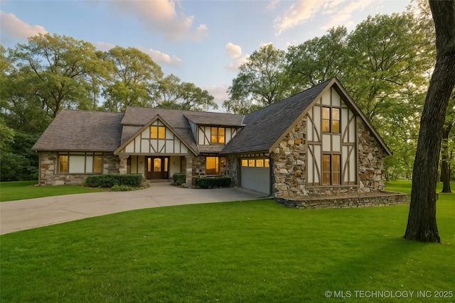 6530 E 106th St, Tulsa, OK 74133 - tudor home with stone siding, concrete driveway, a front yard, and a garage