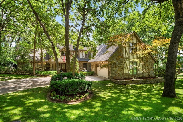 6530 E 106th St, Tulsa, OK 74133 - view of front of home with stone siding, a garage, and a front yard