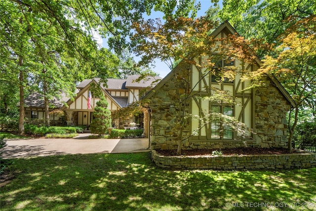 6530 E 106th St, Tulsa, OK 74133 - english style home with stone siding, stucco siding, and a front lawn