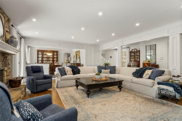 6530 E 106th St, Tulsa, OK 74133 - living room featuring wood finished floors, recessed lighting, and a decorative wall