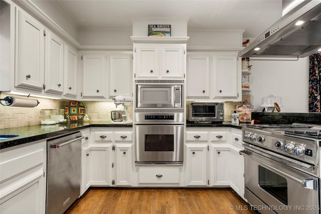 6530 E 106th St, Tulsa, OK 74133 - kitchen featuring appliances with stainless steel finishes, wall chimney exhaust hood, white cabinetry, and ornamental molding