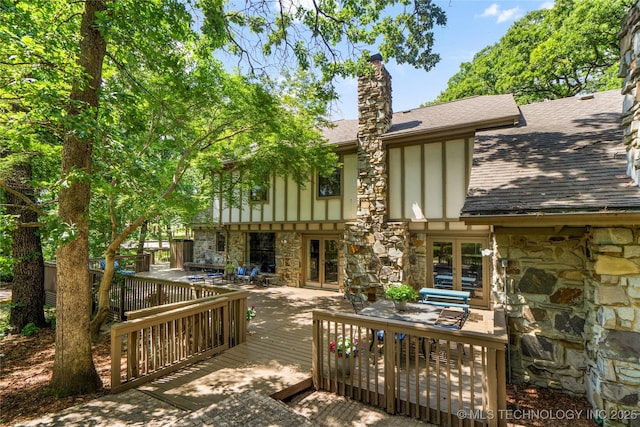 6530 E 106th St, Tulsa, OK 74133 - back of house with stone siding, french doors, roof with shingles, and a deck