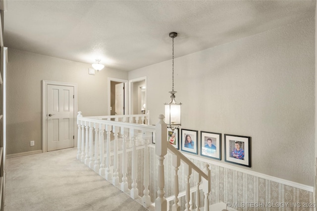 6530 E 106th St, Tulsa, OK 74133 - corridor with an upstairs landing, carpet floors, a textured wall, and a textured ceiling