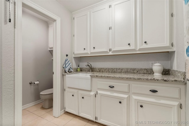 6530 E 106th St, Tulsa, OK 74133 - kitchen with light tile patterned flooring, light stone counters, and white cabinetry