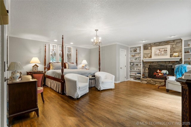 6530 E 106th St, Tulsa, OK 74133 - bedroom featuring wood finished floors, ornamental molding, a chandelier, a textured ceiling, and a stone fireplace