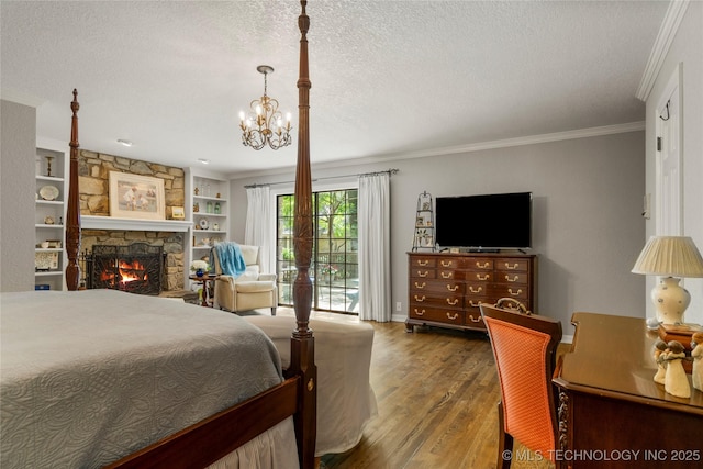 6530 E 106th St, Tulsa, OK 74133 - bedroom featuring wood finished floors, ornamental molding, a textured ceiling, a chandelier, and a stone fireplace