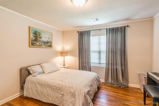 2648 E 2nd St, Tulsa, OK 74104 - bedroom with ornamental molding and wood finished floors