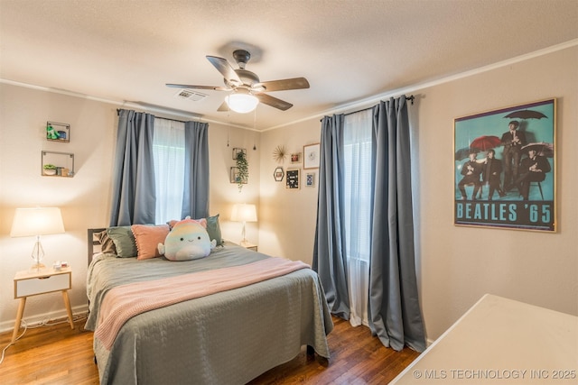 2648 E 2nd St, Tulsa, OK 74104 - bedroom featuring wood finished floors, crown molding, and a ceiling fan