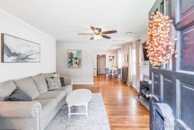 2648 E 2nd St, Tulsa, OK 74104 - living room featuring light wood-style flooring, a ceiling fan, and crown molding