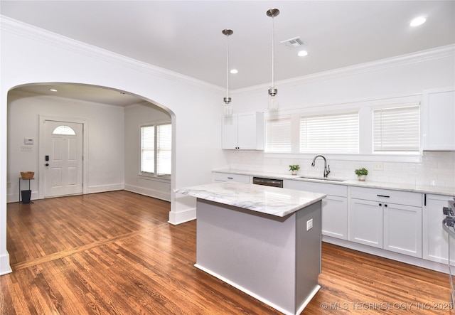 2020 E 14th St, Tulsa, OK 74104 - kitchen featuring arched walkways, crown molding, tasteful backsplash, white cabinetry, and recessed lighting
