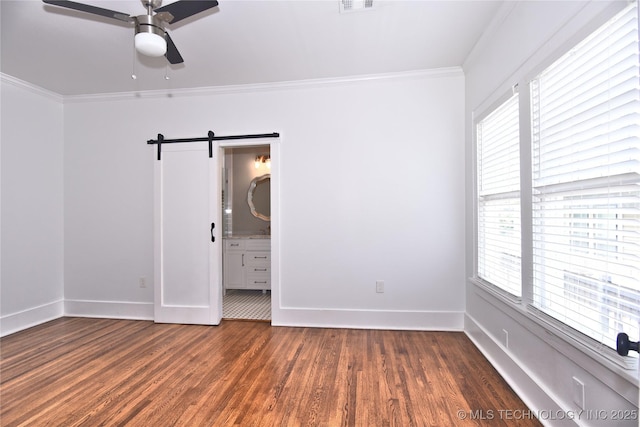 2020 E 14th St, Tulsa, OK 74104 - unfurnished room featuring a barn door, ceiling fan, crown molding, and dark wood finished floors