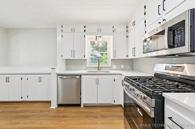 202 W Burnham Ave, Sapulpa, OK 74066 - kitchen featuring stainless steel appliances, white cabinetry, backsplash, light countertops, and ornamental molding