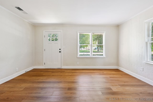 202 W Burnham Ave, Sapulpa, OK 74066 - foyer featuring healthy amount of natural light, crown molding, and light wood-style floors