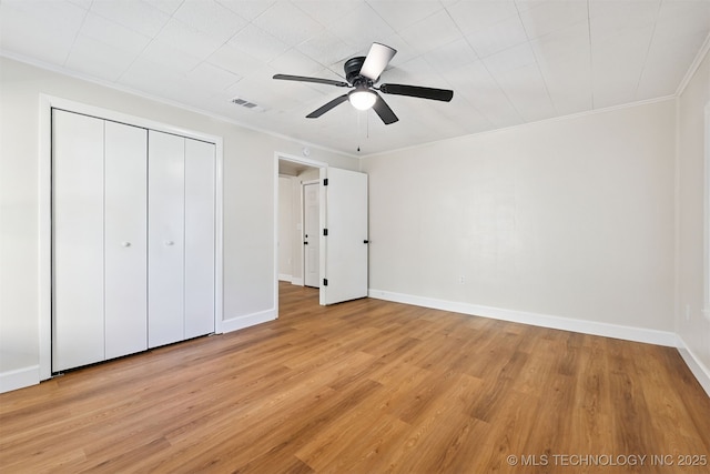 202 W Burnham Ave, Sapulpa, OK 74066 - unfurnished bedroom featuring ornamental molding, light wood-style floors, a closet, and a ceiling fan